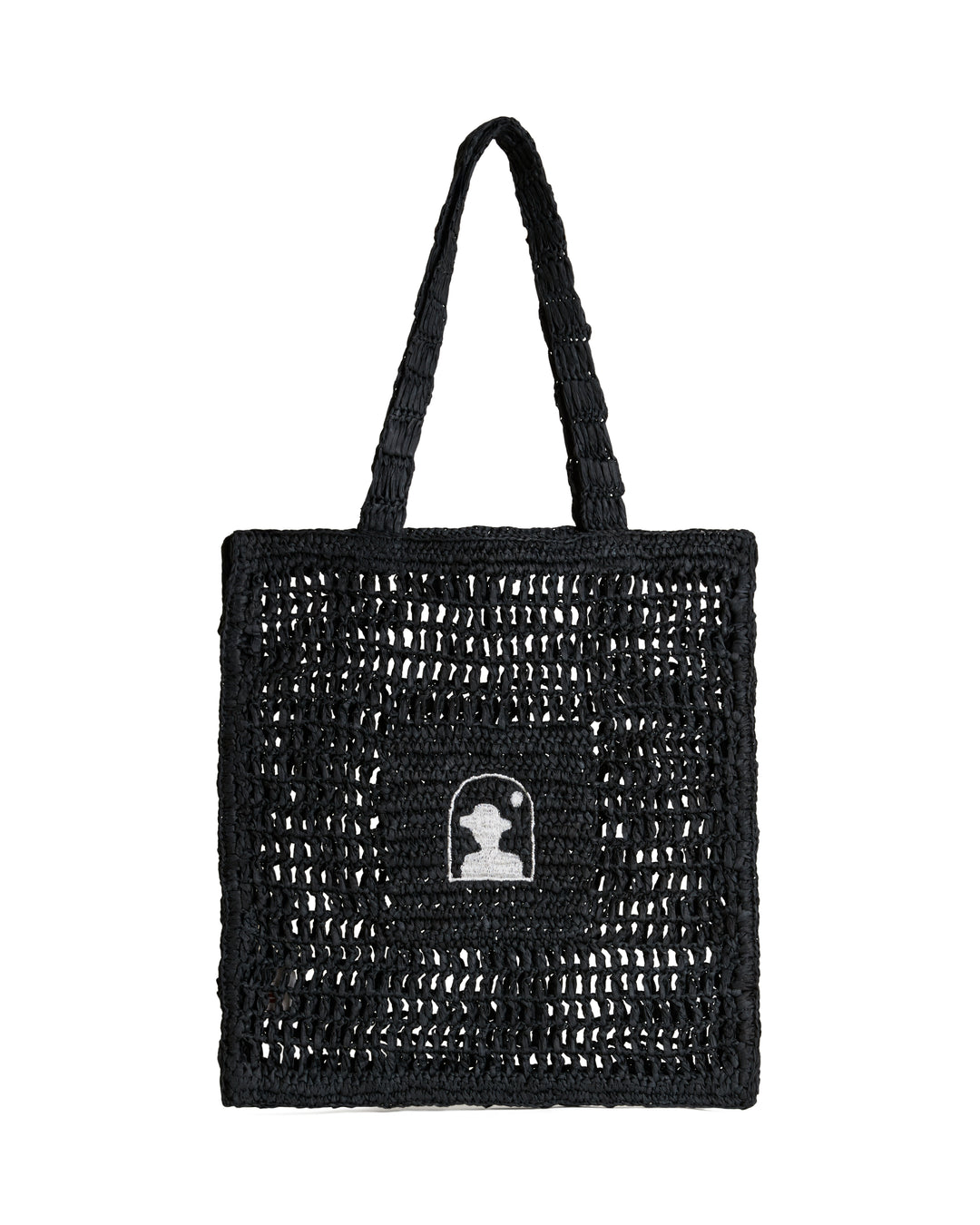The Amabile Raffia Bag - Onyx by Dandy Del Mar, with a white silhouette patch of a human profile on the front, crafted from raffia-effect yarn, isolated on a white background.