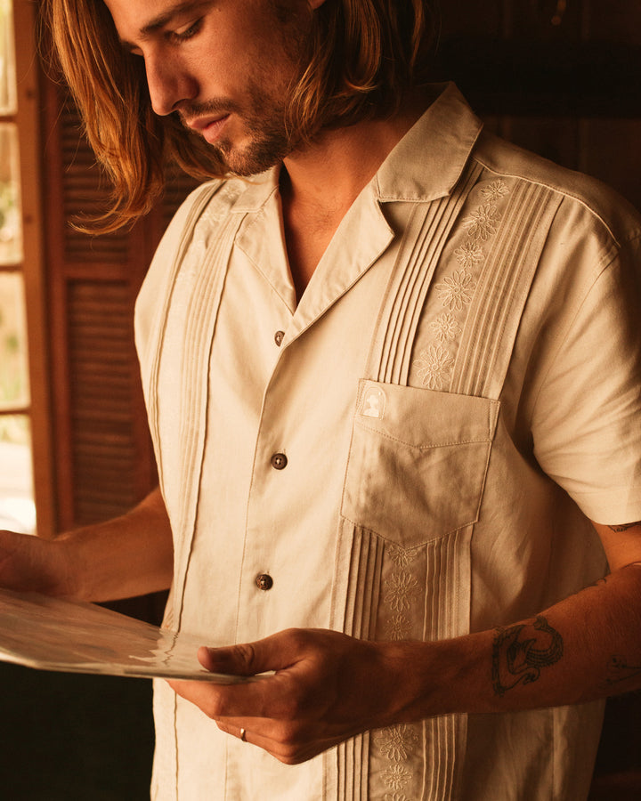 Man looking at vinyl record in the Brisa Linen Shirt