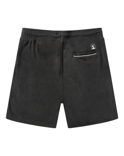 The Gaucho Terry Cloth Shorts - Onyx by Dandy Del Mar feature a dark gray hue, elastic waistband, subtle logo above the single buttoned back pocket with white trim—designed for comfortable leisurewear.