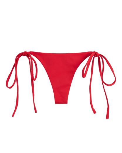 The Kokomo Bottom - Pico by Dandy Del Mar: a red bikini bottom with adjustable side ties, made from sustainable recycled nylon, shown on a plain white background.