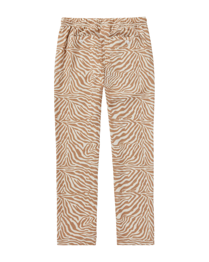 The Lucia Pant - Cortado Sawla Print by Dandy Del Mar features a tan and white zebra design in lightweight linen, with an elastic waistband and front button details for casual comfort. Displayed flat on a white background.