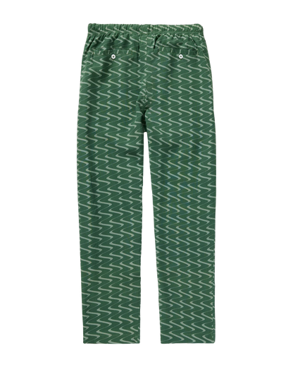 The Lucia Pant - Emerald Tidal Print by Dandy Del Mar features a wavy emerald design, elastic waistband, and two back button pockets in relaxed featherweight linen, shown laid flat on a plain background.
