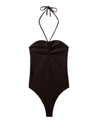 The Elba One Piece - Tierra by Dandy Del Mar is a halter-neck swimsuit in black with ruched bust detailing, high-cut legs, and moderate coverage for a flattering fit.