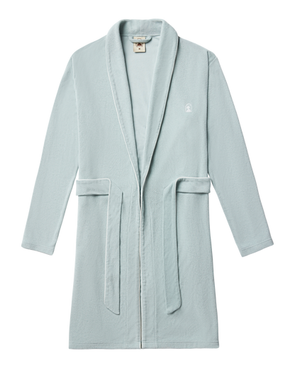 The Tropez Robe - Gulf Blue by Dandy Del Mar, featuring a shawl collar, waist belt, and small embroidered left chest logo, is crafted from ultra-soft terry cloth and displayed flat on a white background.