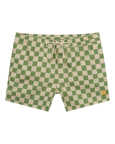 The Ventura Volley Shorts - Arbequina by Dandy Del Mar feature a green and beige checkered design, elastic waist with drawstring, and a small yellow patch on the left leg.