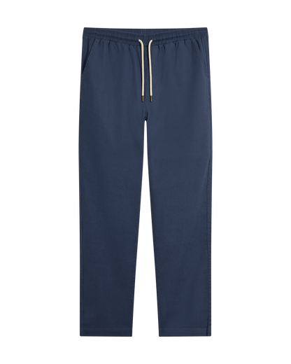 The Brisa Linen Pant - Moontide by Dandy Del Mar features a navy blue hue, elastic waist, and side pockets. Shown flat on white, these pants offer relaxed style and comfort—ideal for your next vacation.