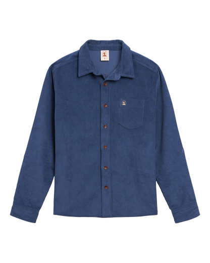 The Corsica Corduroy Shirt - Moontide by Dandy Del Mar features blue 8-wale corduroy, long sleeves, chest pocket, brown buttons, and a tailored relaxed fit. Shown laid flat on a white background.