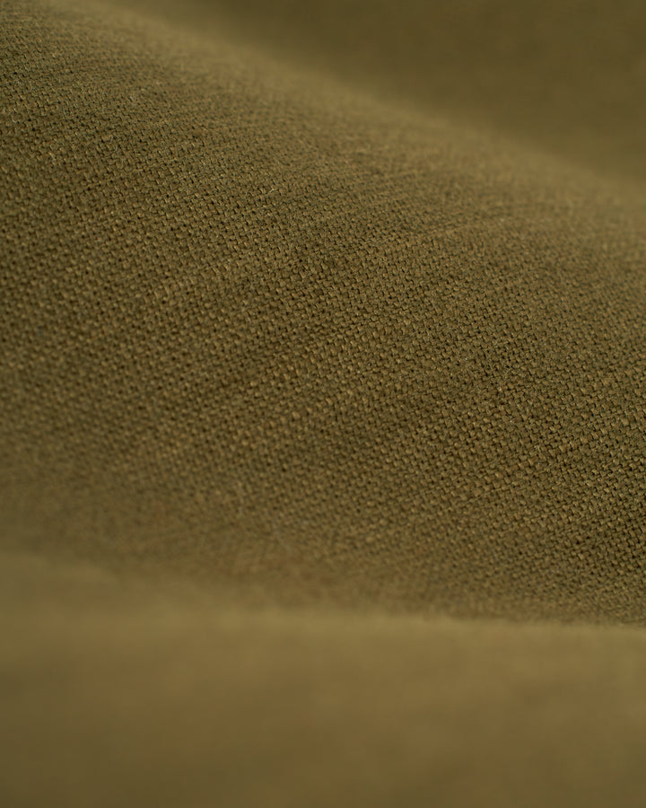 Close-up view of a textured brown fabric, with visible weave and fibers, reminiscent of the fine detailing seen in The Brisa Linen Blazer - Berdea by Dandy Del Mar.