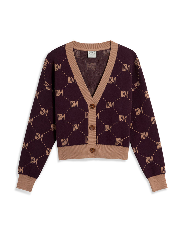 A chic cropped silhouette cardigan in a brown and maroon geometric monogram pattern with "LDM" initials throughout, known as The Canela Cardigan - Amethyst by Dandy Del Mar.