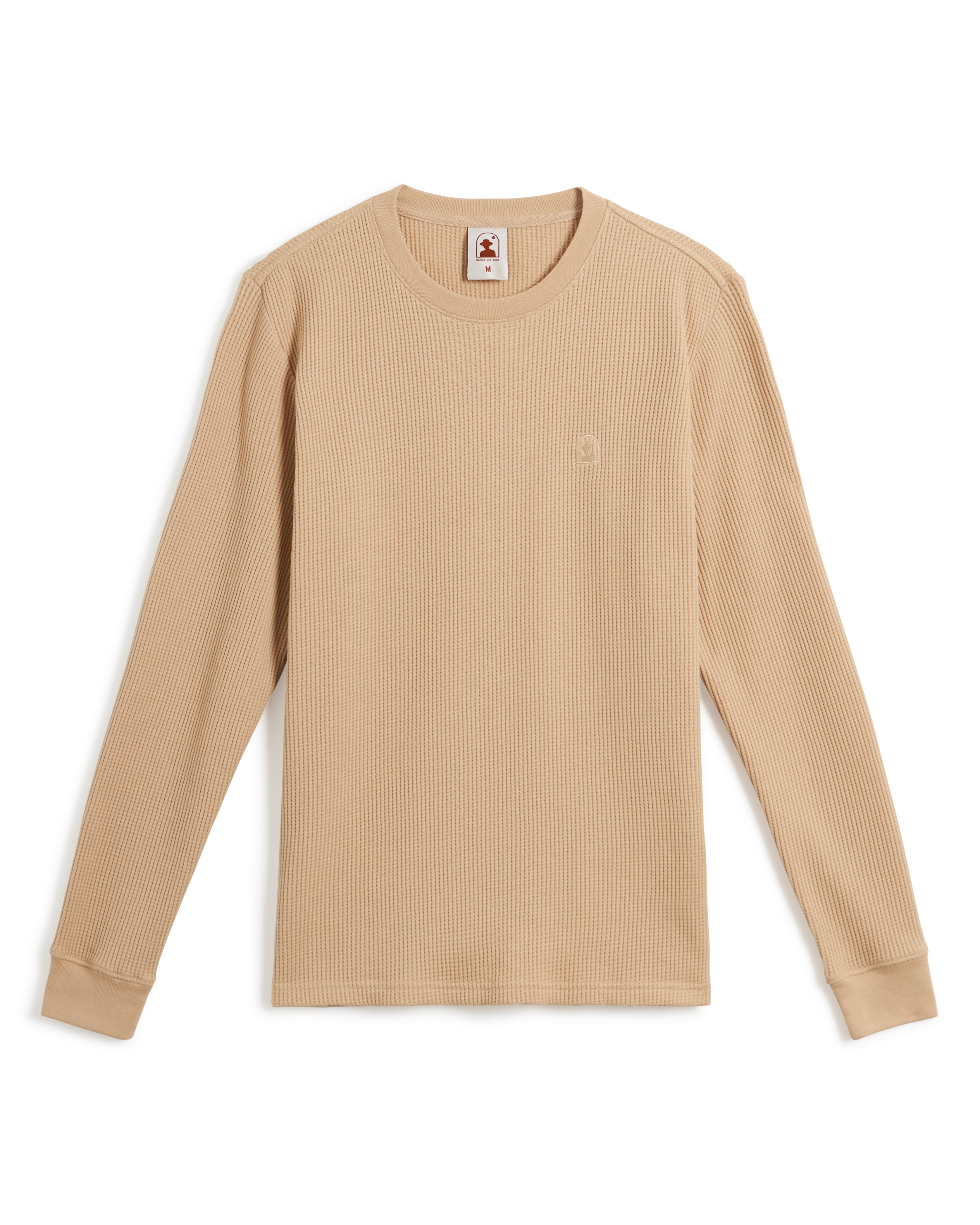 A beige long-sleeve waffle knit shirt with ribbed cuffs and a small embroidered Dandy Del Mar logo on the chest, known as The Cannes Long Sleeve Shirt in Truffle by Dandy Del Mar.