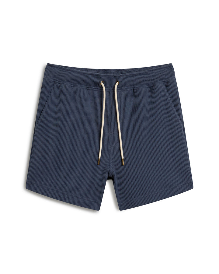 Dandy Del Mar's "The Cannes Waffle Knit Shorts - Moontide" are blue ribbed swim trunks featuring a drawstring and side pockets.