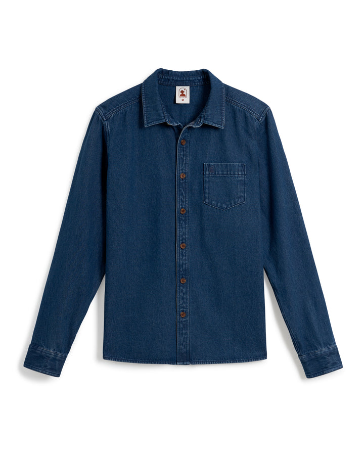 The Cartagena Denim Shirt - Indigo by Dandy Del Mar is a blue denim, collared button-up design featuring brown buttons and a chest pocket, finished with a tailored fit.