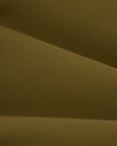 Close-up of The Cavoli Swim Short - Berdea by Dandy Del Mar in olive green, showcasing its textured performance fabric and versatile 4-way stretch.