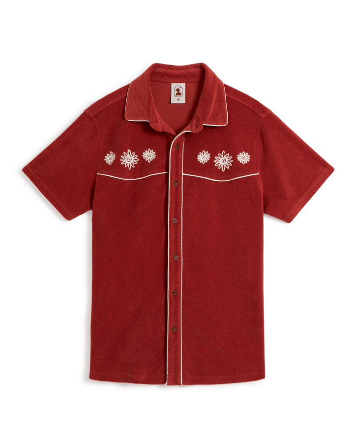 Discover the ultimate blend of comfort and style with Dandy Del Mar's Gaucho Terry Cloth Shirt - Rouge. This short-sleeved, red button-up shirt features exquisite white floral embroidery on the chest and elegant white piping along the seams.