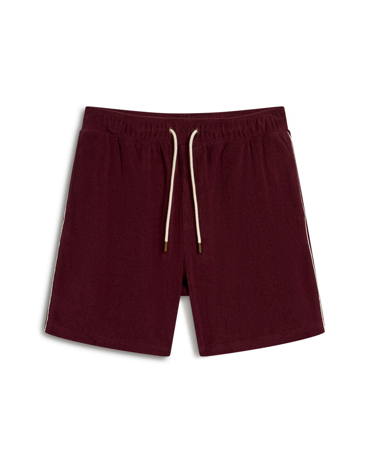 The Gaucho Terry Cloth Short by Dandy Del Mar in Bordeaux features a drawstring waistband and white side stripes.