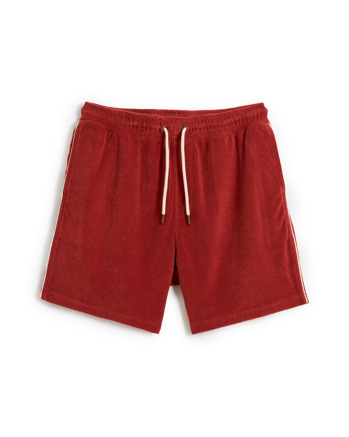 A pair of The Gaucho Terry Cloth Short - Rouge by Dandy Del Mar, featuring an elastic waistband, white drawstring, and white side trim, laid flat against a white background.