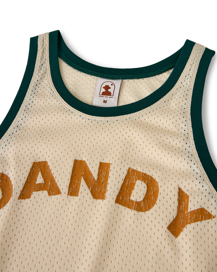 Yellow mesh sports jersey with green trim, featuring the "DANDY" logo in brown. Inside the collar, the label shows Dandy Del Mar's logo and size "M." Officially called The Kaena Mesh Tank in Sabbia.