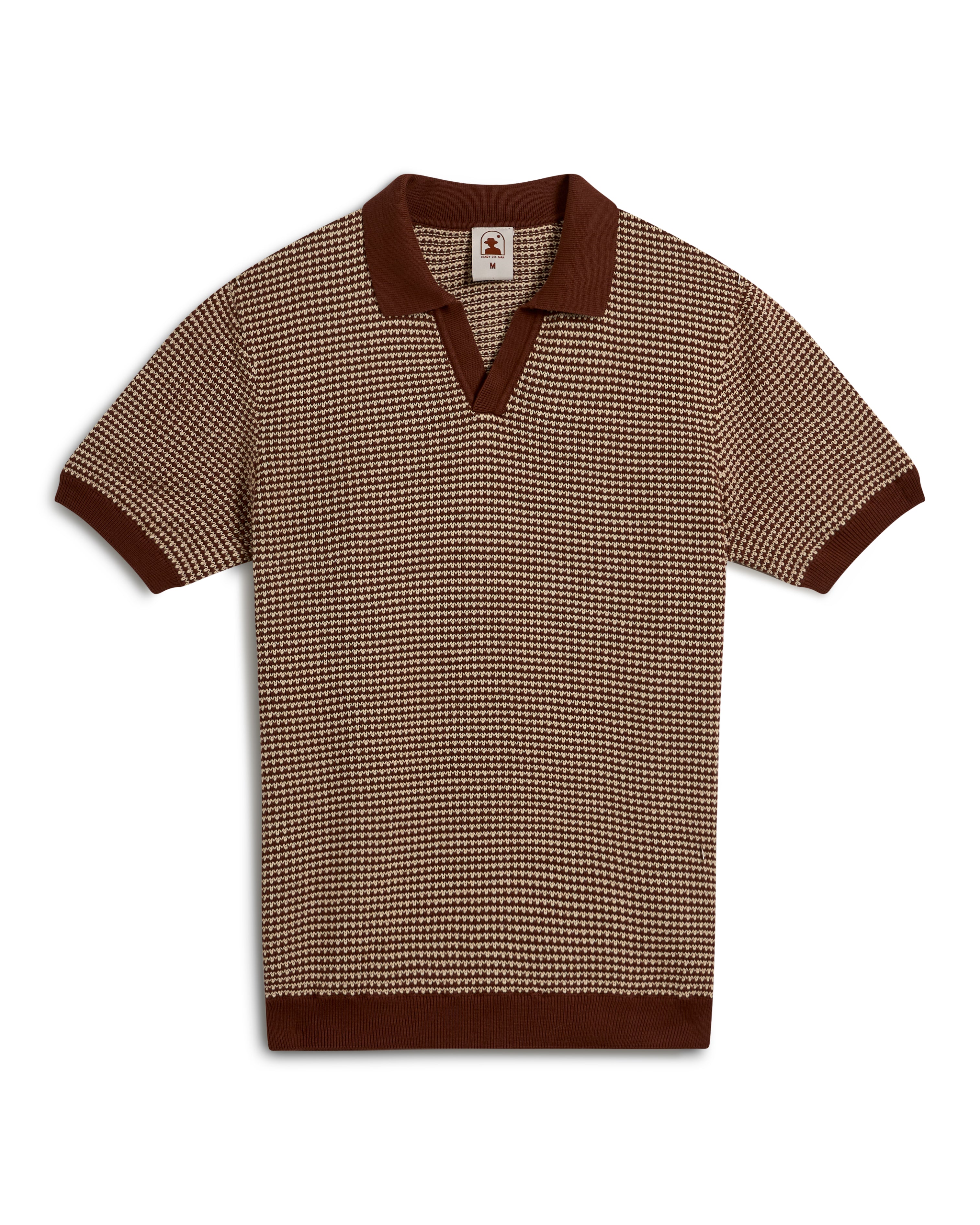 The Palamos Knit Polo Shirt - Cappuccino by Dandy Del Mar is a brown and beige houndstooth short-sleeve knit shirt with a V-neck, dark brown collar, and cuffs.