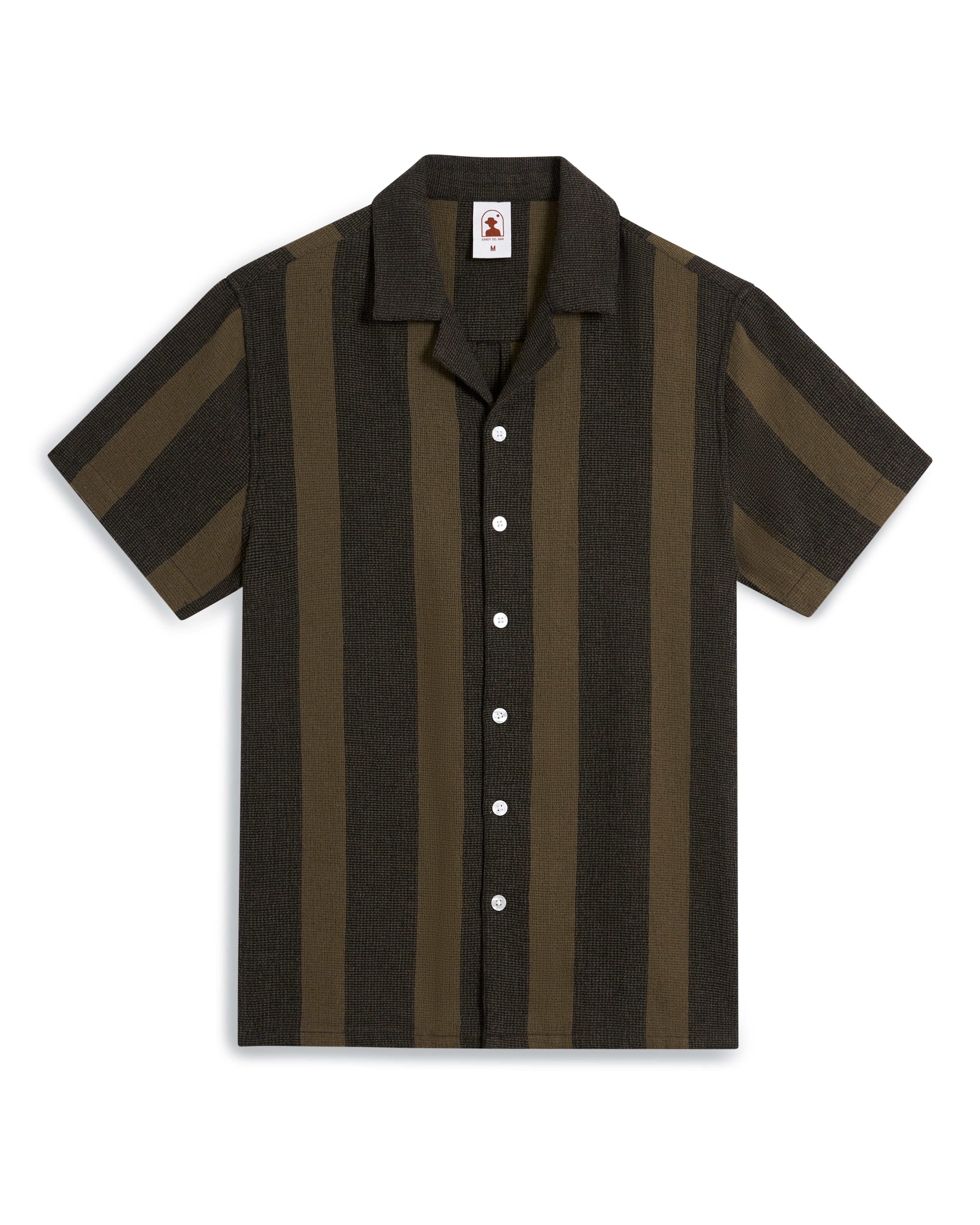 The Palma Shirt - Onyx by Dandy Del Mar is a short-sleeved, collared shirt featuring alternating dark and light vertical stripes with white buttons.