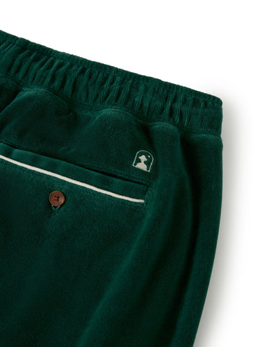 Close-up of The Rio Velour Shorts - Albero by Dandy Del Mar, featuring an elastic waistband, a back pocket with white piping and button, and a small embroidered logo above the pocket.