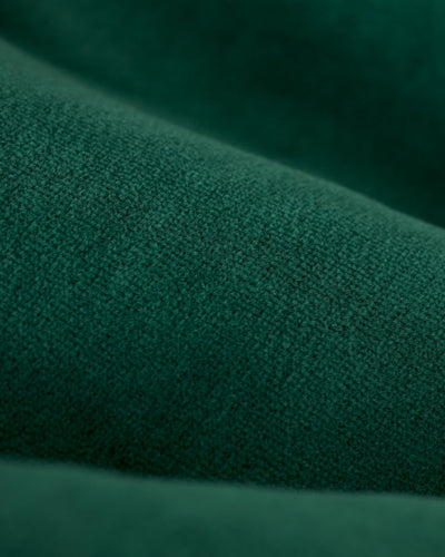 Close-up of green textured fabric with visible fibers and soft folds, highlighting the plush material of The Rio Velour Shorts - Albero by Dandy Del Mar.