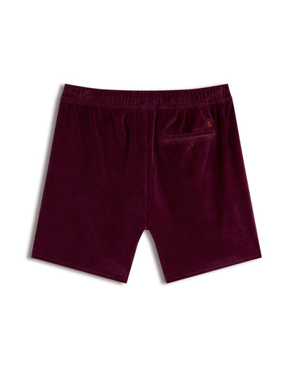 Back view of The Rio Velour Short - Bordeaux by Dandy Del Mar, showcasing an elastic waistband and single buttoned back pocket—ideal for a stylish athletic look.
