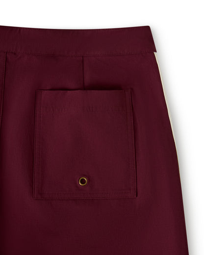 Close-up of The Stirata Swim Short - Bordeaux by Dandy Del Mar featuring a square pocket with a metal eyelet on the back.