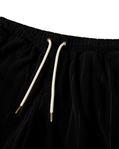 Close-up of The Tropez Jacquard Shorts in Onyx by Dandy Del Mar, featuring an elastic waistband and white drawstrings with gold-colored metal tips.