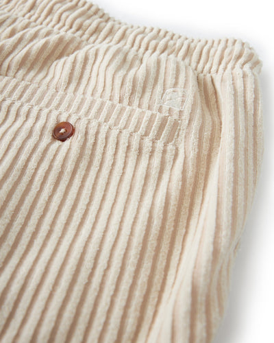 Close-up of The Tropez Jacquard Shorts - Scallop Stripe by Dandy Del Mar, featuring an elastic waistband, single back pocket with a brown button, and subtle vertical stripes for lounge-worthy comfort.