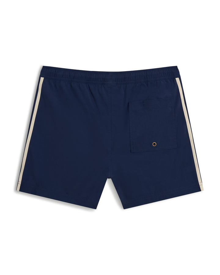 The Ventura Volley Short - Anchor by Dandy Del Mar is a navy blue swim short with white side stripes, an elastic waistband, a single back pocket with a small grommet, and features a micro mesh liner for added comfort.