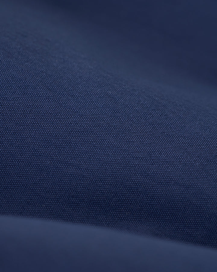 Close-up of dark blue fabric with a smooth, fine texture reminiscent of the micro mesh liner in The Ventura Volley Short - Anchor by Dandy Del Mar.