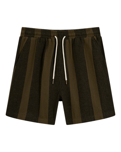 The Palma Short - Onyx by Dandy Del Mar features olive green and black stripes, an elastic waistband, white drawstring, and side pockets—ideal with a camp collar shirt, shown on a plain black background.