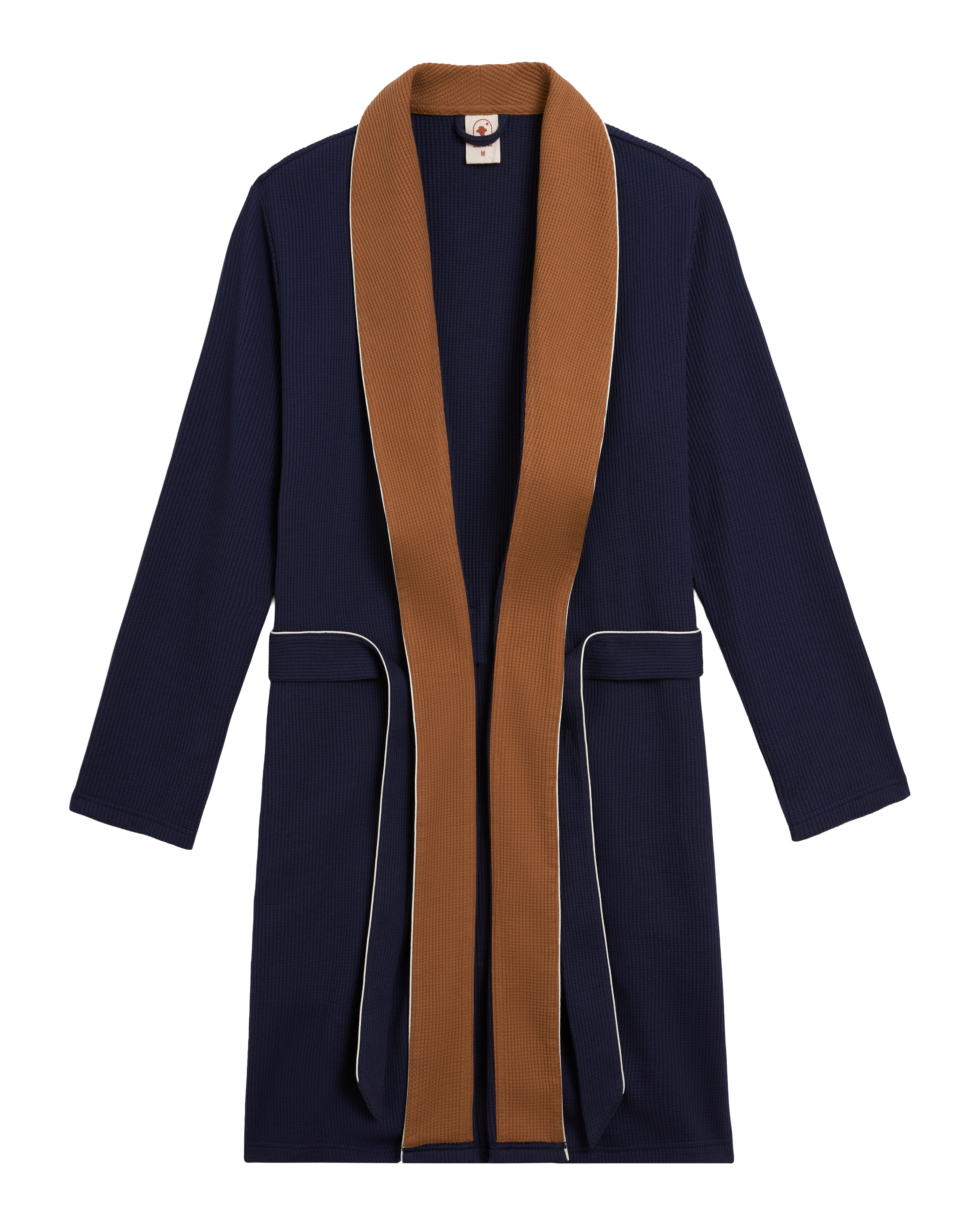 The Cannes Robe - Luxe Navy by Dandy Del Mar features long sleeves, a brown shawl collar, white piping, two front pockets, and soft waffle knit fabric—all laid flat on a white background.