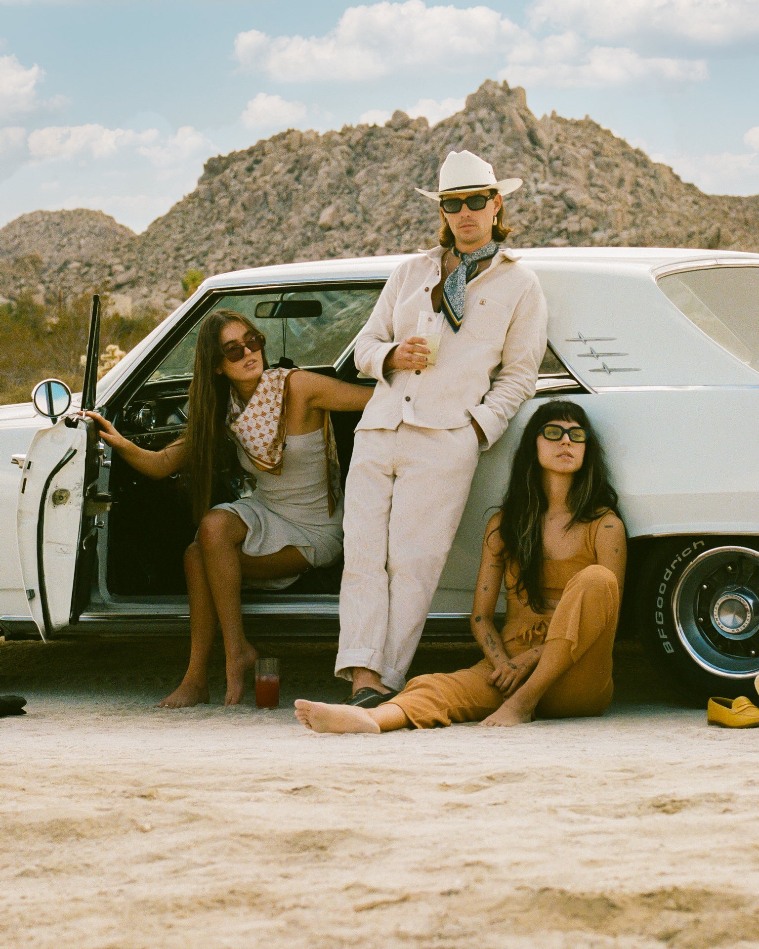 A group of people sitting in front of a Dandy Del Mar Corsica Corduroy Pant in Alabaster White.