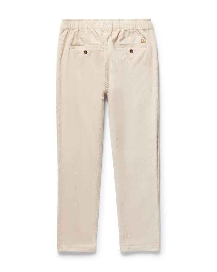 A pair of Corsica Corduroy Pants in Alabaster White by Dandy Del Mar on a white background.