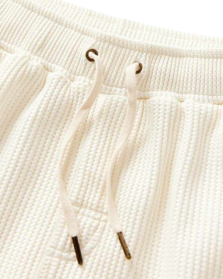 A close up of a pair of Dandy Del Mar Cannes Waffle Knit Shorts in Vintage Ivory.