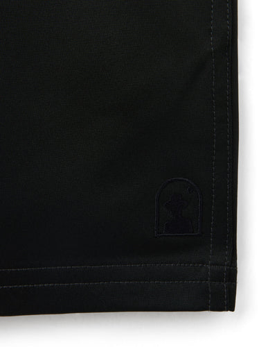 Close-up of the hem on Dandy Del Mar's The Mallorca Swim-Walk Shorts - Onyx, featuring visible stitching, adjustable side fasteners, and a small embroidered logo near the bottom edge.