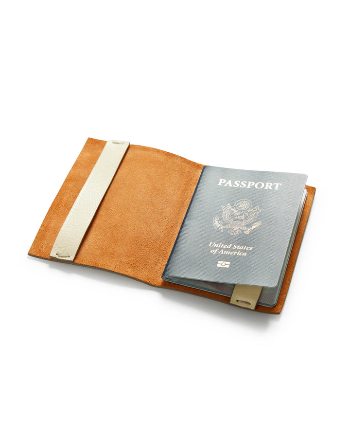 The Departure Passport Carrier - Alabaster White by Dandy Del Mar is open on a white surface.